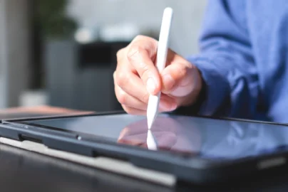 Person reviewing a printed last will and testament document on a tablet and legal papers in South Africa